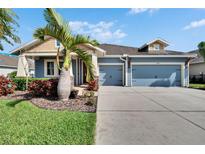 Charming single-story home featuring a two-car garage, beautifully landscaped yard, and classic architectural design at 6645 Current Dr, Apollo Beach, FL 33572