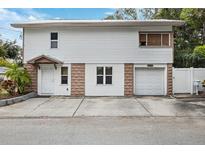 Two-story house with attached garage and small front yard at 832 13Th N Ave, St Petersburg, FL 33701