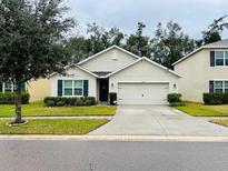 Two-story house with attached garage and manicured lawn at 10029 Warm Stone St, Thonotosassa, FL 33592