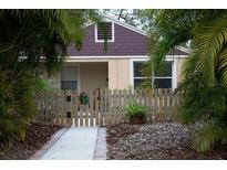 Cute bungalow with a fenced yard and walkway at 1018 E Hanna Ave, Tampa, FL 33604