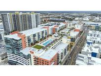 Aerial view of modern apartment community with pool and city views at 1120 E Kennedy Blvd # 413, Tampa, FL 33602