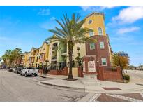 Brick building exterior with palm trees and street view at 1910 E Palm Ave # 8214, Tampa, FL 33605