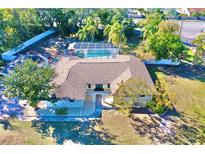 Single-story home with pool and large backyard at 2142 Hickory Gate W Dr, Dunedin, FL 34698