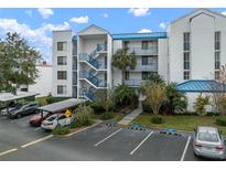 Exterior view of a condo building with parking and landscaping at 2424 W Tampa Bay Blvd # L102, Tampa, FL 33607