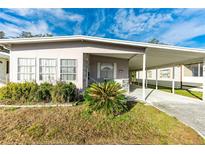 Mobile home exterior with carport and landscaping at 5149 Jo St, Zephyrhills, FL 33542