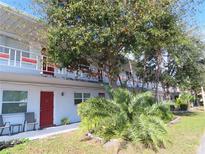 Two-story building with red and white accents, balconies, and landscaping at 5920 18Th N St # 21, St Petersburg, FL 33714