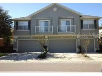 Two-story townhome with attached garage and balconies at 6769 Breezy Palm Dr, Riverview, FL 33578