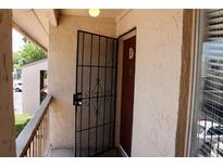 Inviting condo entry with security gate and updated door at 7533 Pitch Pine Cir # 18, Tampa, FL 33617