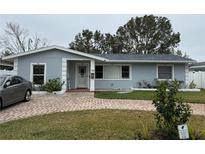 Newly painted light gray home with a brick driveway and well-maintained lawn at 758 44Th Ne Ave, St Petersburg, FL 33703