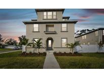 Two-story house with light beige siding, gray door, and walkway at 1740 W Saint Louis St, Tampa, FL 33607