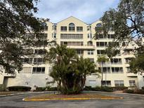 Front view of a multi-story building with palm trees and landscaping at 2333 Feather Sound Dr # B301, Clearwater, FL 33762