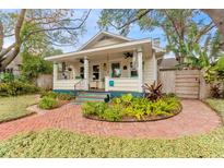 Charming bungalow with a brick pathway, lush landscaping, and a welcoming front porch at 2545 2Nd N Ave, St Petersburg, FL 33713