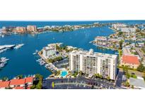 Aerial view of waterfront property, showing building, pool, and marina at 255 Dolphin Pt Pt # 603, Clearwater Beach, FL 33767