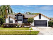 Two-story house with a dark gray garage door and a well-manicured lawn at 2893 Allapattah Dr, Clearwater, FL 33761