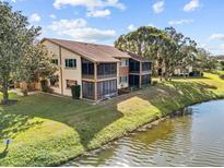 Aerial view of condo community with water access and lush landscaping at 3833 Lighthouse Way, New Port Richey, FL 34652