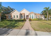 Beautiful two-story home with a brick facade and lush landscaping at 530 Ponce De Leon Blvd, Belleair, FL 33756