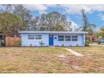 Charming light blue house with a well-maintained lawn and walkway at 674 61St S Ave, St Petersburg, FL 33705