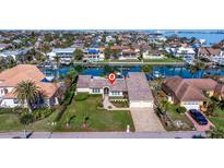 Bird's eye view of waterfront property showcasing canal access and neighborhood at 127 Sands Point Dr, St Petersburg, FL 33715