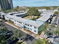 Aerial view of an apartment building complex with ample parking and landscaping at 6915 Avenue Des Palais # 2B, South Pasadena, FL 33707