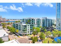 Aerial view of a modern multi-unit building with water and city views at 912 Channelside Dr # 2409, Tampa, FL 33602