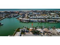 Aerial view of waterfront home with private dock and boat slips at 11650 4Th E St, Treasure Island, FL 33706