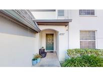 Inviting front entrance with a teal door, stone pathway, and lush landscaping at 1237 N Mcmullen Booth Rd, Clearwater, FL 33759