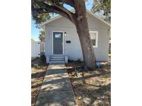 Charming bungalow with gray exterior, walkway, and mature tree at 1916 Seminole S Blvd, St Petersburg, FL 33705