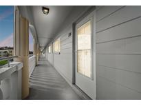 Well-lit hallway with access to unit 104 at 2460 Franciscan Dr # 20, Clearwater, FL 33763