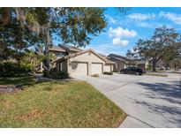 Two-story condo with attached garage and landscaped grounds at 3079 Landmark Blvd # 1606, Palm Harbor, FL 34684