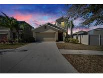 Two-story house with a two-car garage, and a well-manicured lawn at 6834 Blue Moon Way, Sun City Center, FL 33573