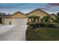 Attractive single-story house with a three-car garage and manicured landscaping at 2126 Larchwood Ct, Trinity, FL 34655