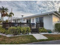 White single story home with deck and landscaped yard at 236 Carol Dr # 236, Seminole, FL 33772