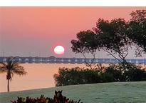 Stunning sunrise over the water with bridge in the distance at 2616 Cove Cay Dr # 102, Clearwater, FL 33760