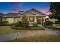 Charming single-story home with front porch and landscaped yard at 302 Latitude Pl, Apollo Beach, FL 33572