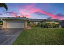 Charming single-story home with well-maintained lawn and attached two-car garage on a picturesque lot at 6909 13Th N Ave, St Petersburg, FL 33710