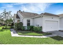 Single-story villa with attached garage and landscaped front yard at 20922 Jaffa Ln, Land O Lakes, FL 34637