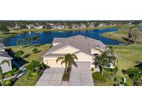 Property features a two-car garage and lakefront view at 2501 Sapphire Greens Ln, Sun City Center, FL 33573