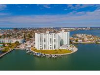 Aerial view of waterfront condo building with boat slips and city views at 400 64Th Ave # 508, St Pete Beach, FL 33706