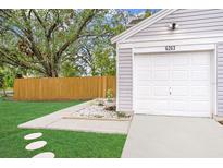 Updated garage with new driveway and landscaping at 6263 Oak Cluster Cir, Tampa, FL 33634