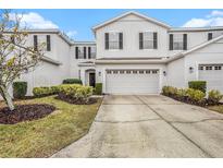Two-story townhome with attached garage and well-manicured landscaping at 8110 Hampton View Ln, Tampa, FL 33647