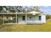 Charming single-story home with a covered carport and a quaint front porch at 9415 Forest Hills Dr, Tampa, FL 33612