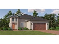 One-story home with a brown garage door and orange front door at 10852 Ibis Brook Ct, Land O Lakes, FL 34638