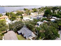 Aerial view showing a charming blue house with a gray roof, nestled in a quiet neighborhood at 1815 2Nd E Ave, Bradenton, FL 34208