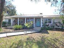 Charming ranch house with a covered porch and landscaped yard at 3009 Jim Johnson Rd, Plant City, FL 33566