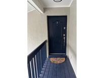 Inviting condo entry with a dark blue door and a floral doormat at 306 S Habana Ave # 7, Tampa, FL 33609