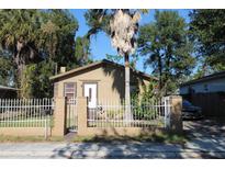 Tan house with white fence and palm tree in front yard at 3504 E 22Nd Ave, Tampa, FL 33605