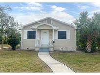 Tan house with white trim, front porch, and small yard at 4562 3Rd S Ave, St Petersburg, FL 33711