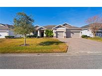 Two-story house with a two-car garage and landscaped yard at 5149 Jennings Trl, Brooksville, FL 34601