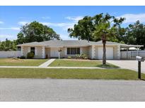 Attractive single-story home with a well-maintained lawn and driveway at 7304 Gates Cir, Spring Hill, FL 34606