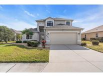 Two-story house with a two-car garage and well-maintained lawn at 8243 47Th Street E Cir, Palmetto, FL 34221